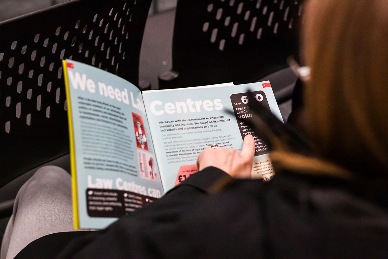 Person reading GMLC Manifesto brochure