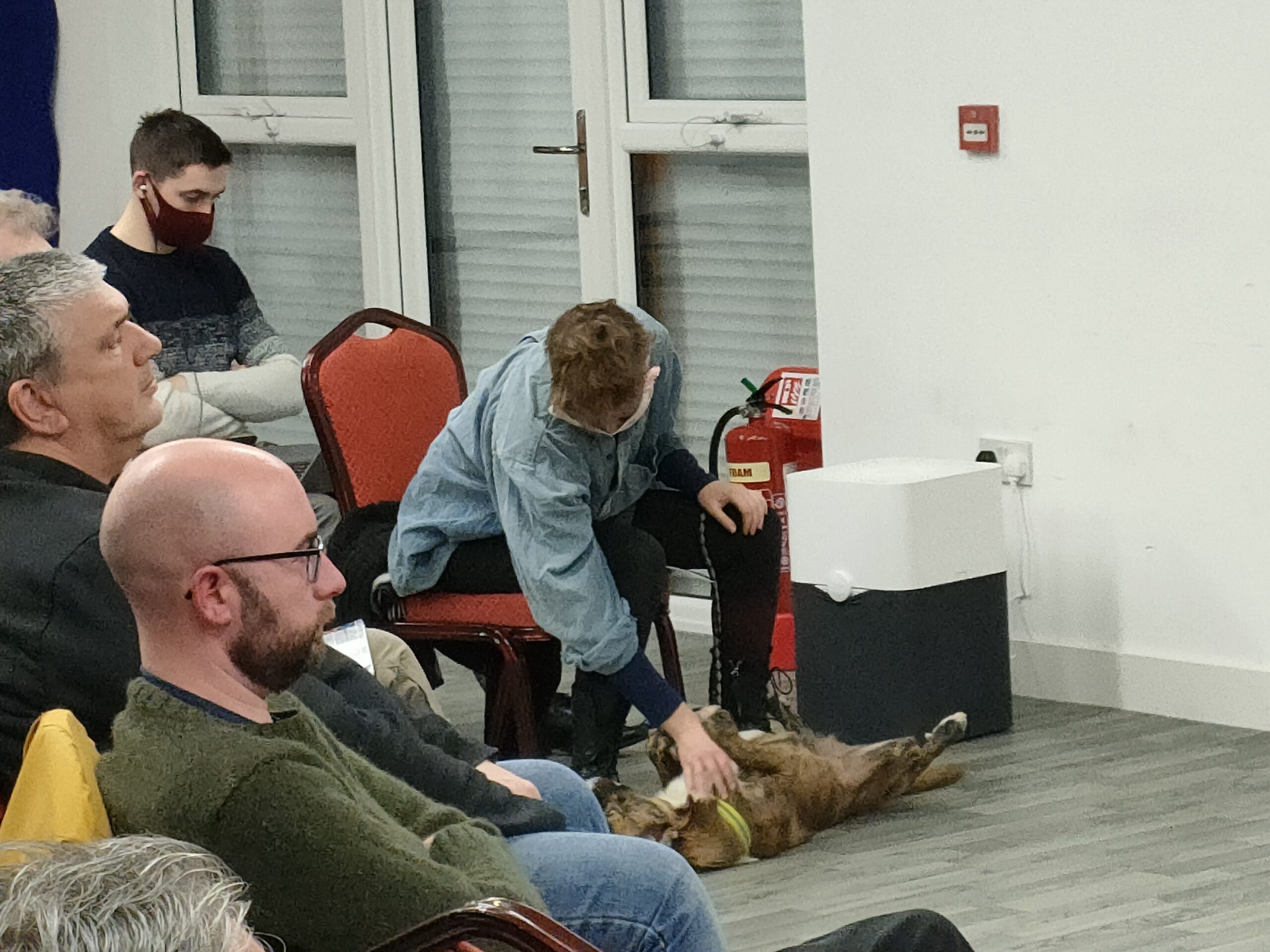 An attendee strokes their dog during the meeting.